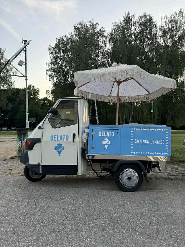 Piaggio Ape 50 gelato ice cream truck — full side view with blue freezer box and fringed parasol